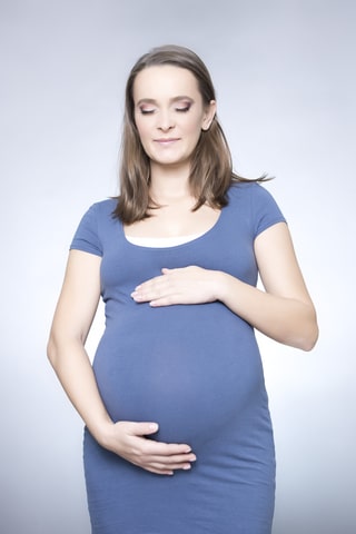 Pregnant woman wearing a blue dress