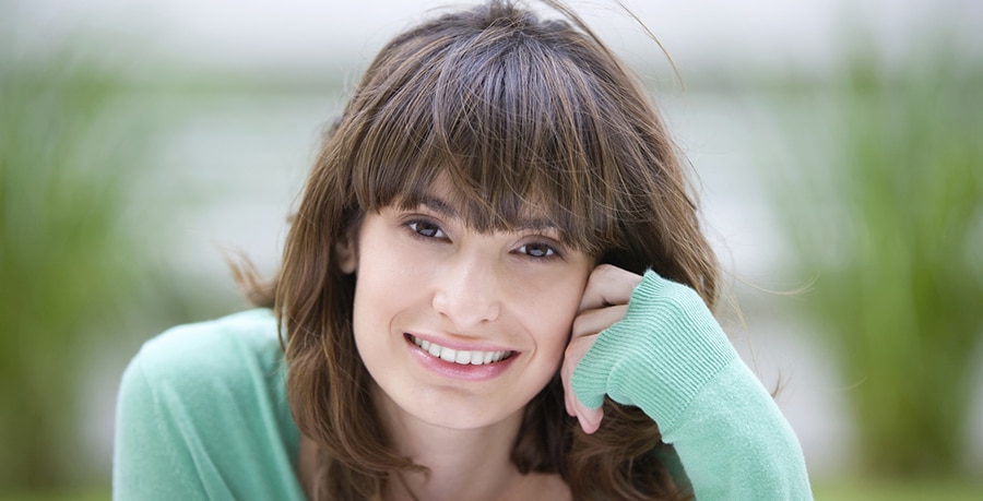 Happy woman sitting outside