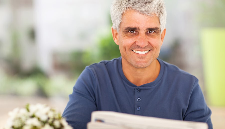 mature man reading newspaper