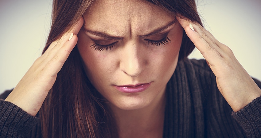 Young woman with painful headache