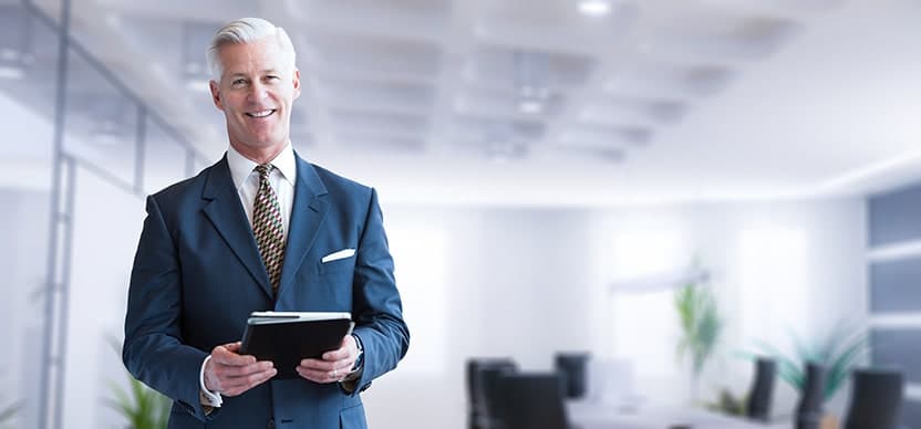 Senior businessman at his office. With dental implants he's able to have the confidence to tackle all the hard mergers.