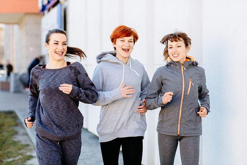 3 athletic women jogging outside in sunny morning and 3 steps to dental implants