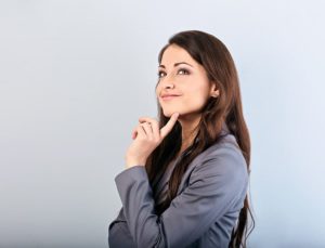 beautiful young woman contemplating her questions on laser dentistry
