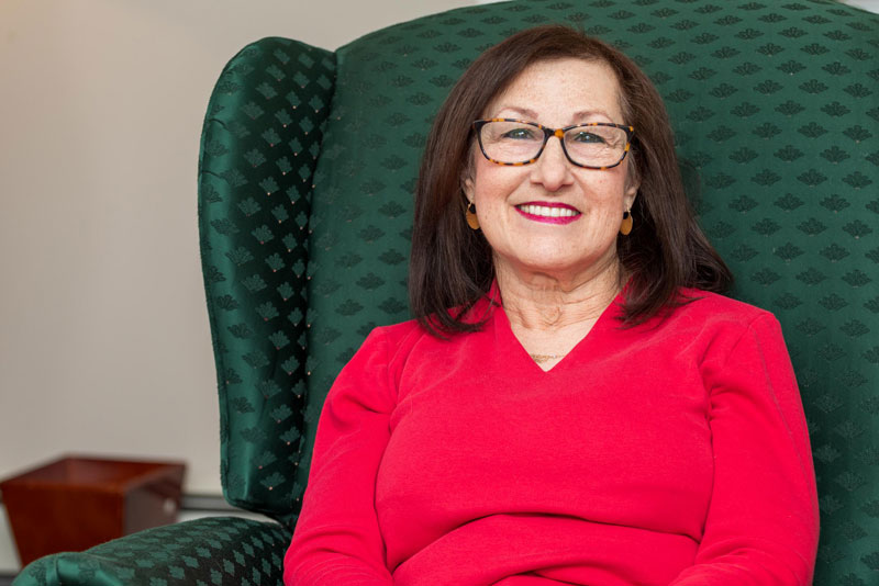 Joan Full Arch Dental Implants Patient Smiling On The Consultation Chair