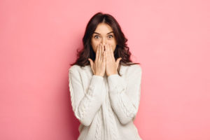 Dental Patient Shyly Covering Her Missing Tooth