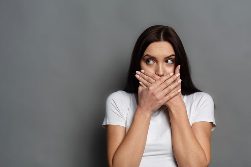 Dental Patient Covering Her Missing Tooth