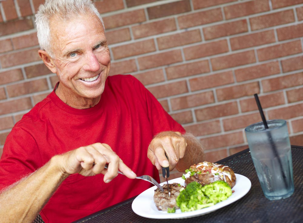 Dental Patient Eating A Steak After Getting A Single Dental Implant